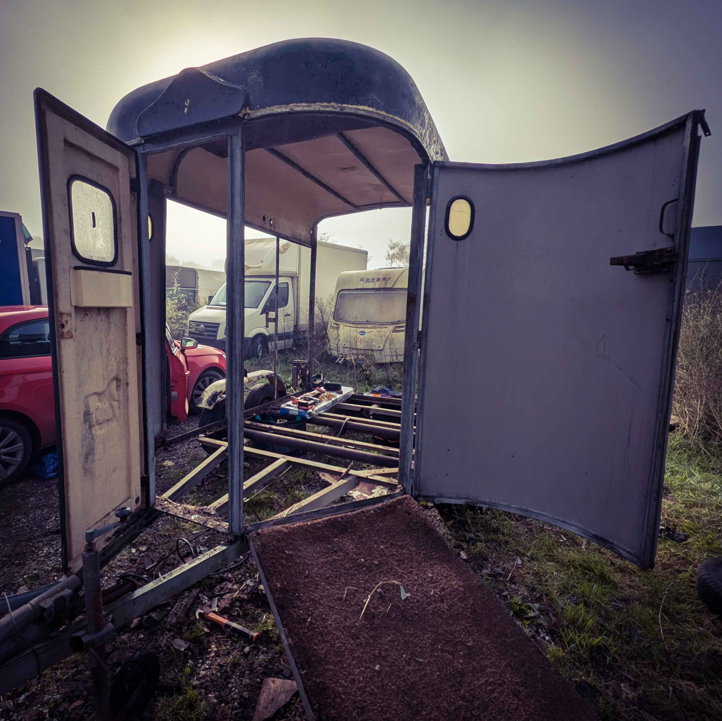 The horsebox interior framed out, light coming through, the space beginning to define itself